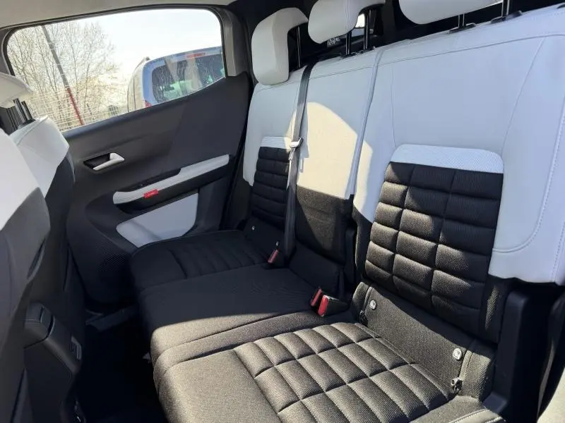 Vue latérale intérieure des sièges arrière noirs et blancs du Citroën C3 Aircross 2026, version 7 places.