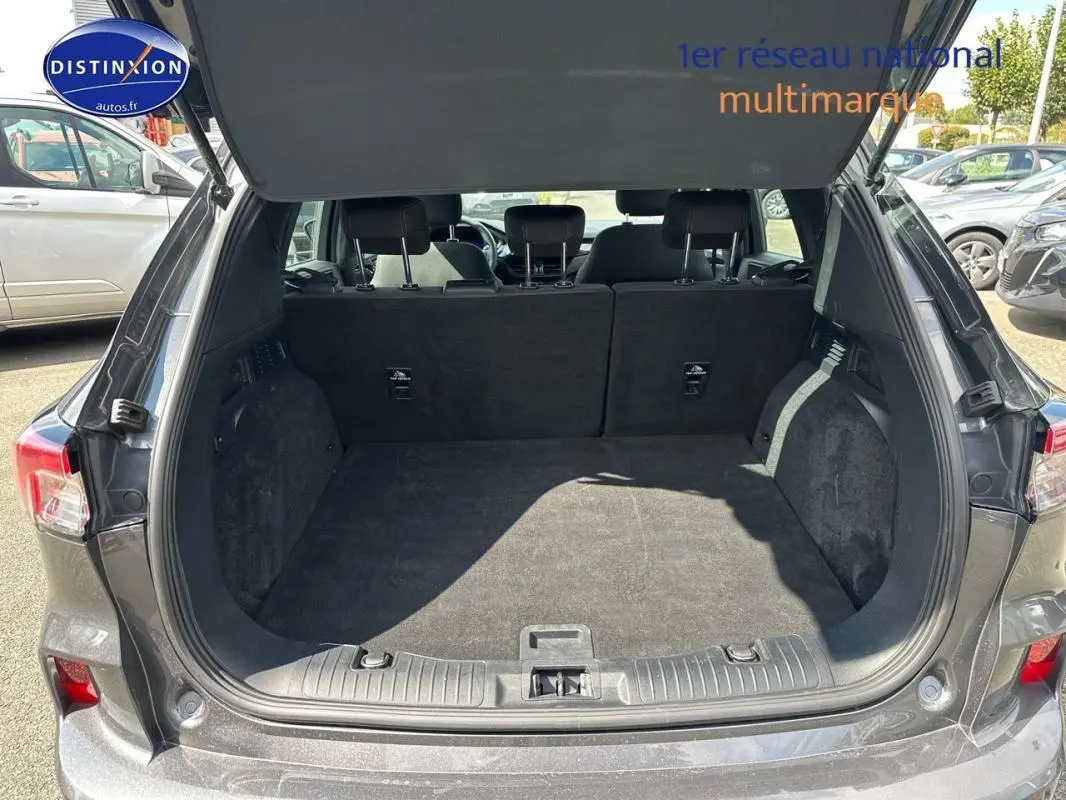Coffre ouvert vu de l'arrière d'un Ford Kuga gris foncé 2022, montrant un espace de chargement spacieux et propre.