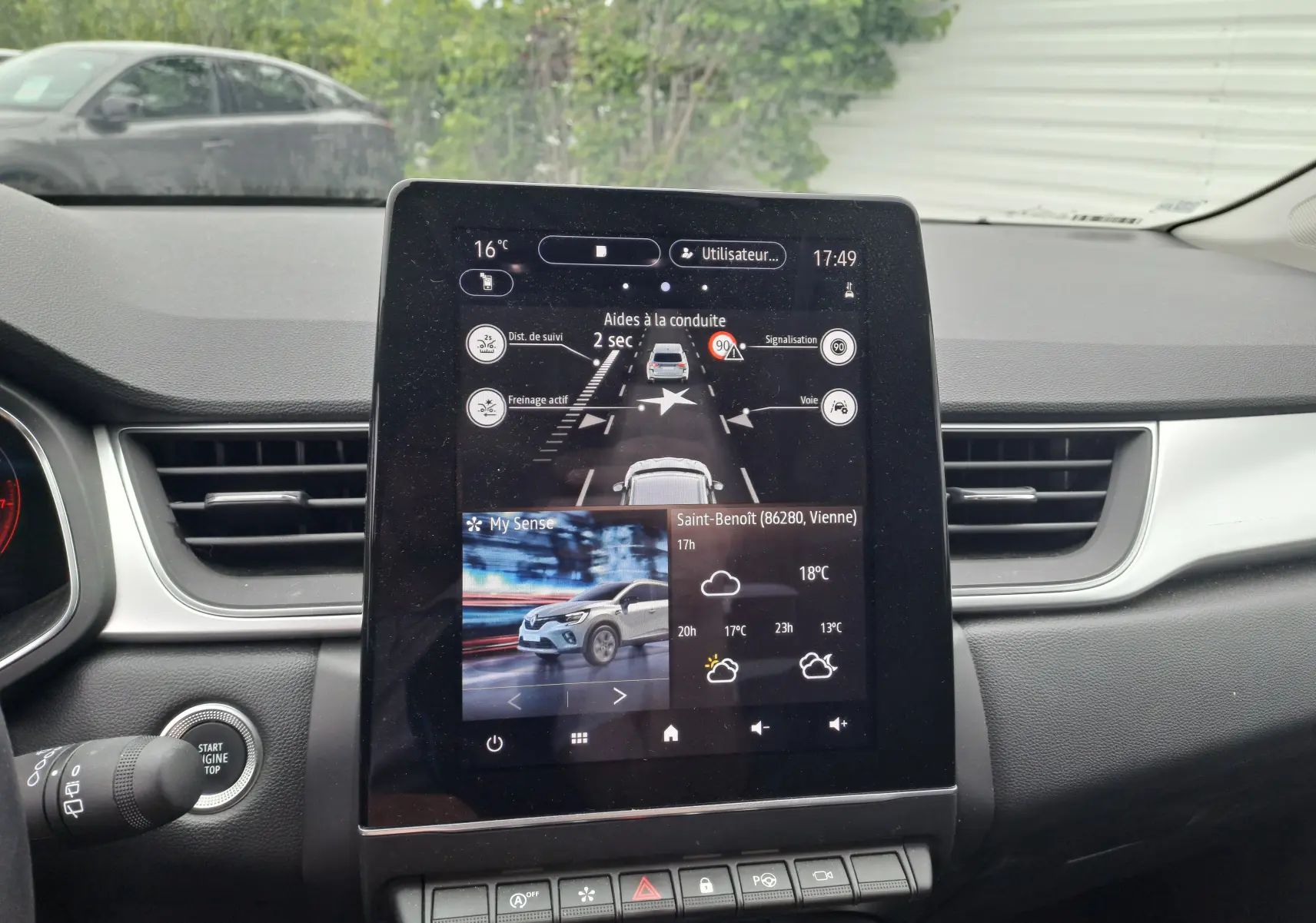 Écran tactile central du tableau de bord du Renault Captur TCE 90CH TECHNO 2024 affichant aides à la conduite et météo.