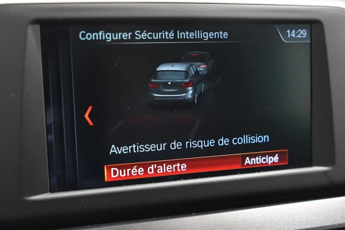 Écran intérieur de la BMW Série 2 Active Tourer blanc montrant l'alerte de risque de collision en mode anticipé.