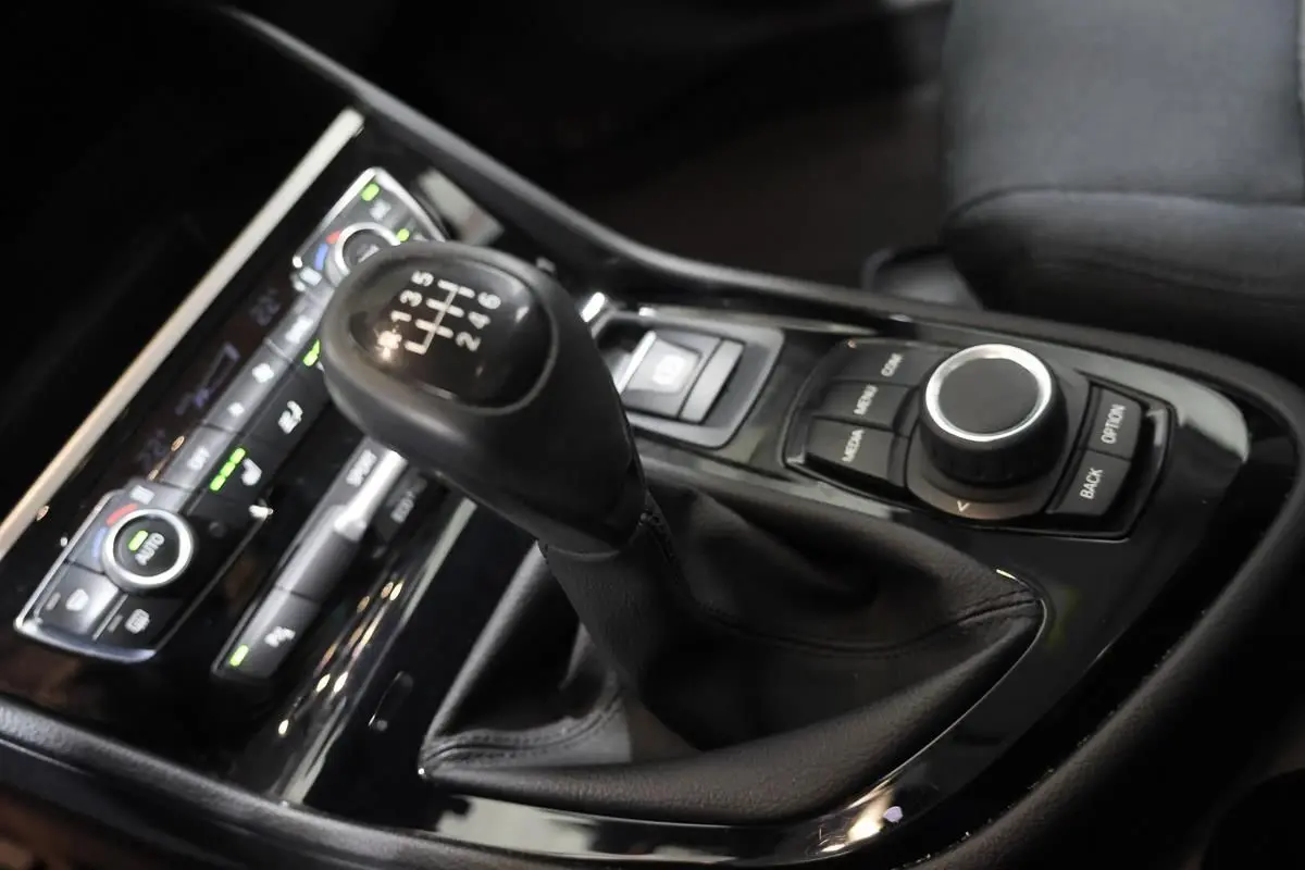 Gros plan sur la commande de boîte manuelle et la console centrale noire du BMW Série 2 Active Tourer 216d.