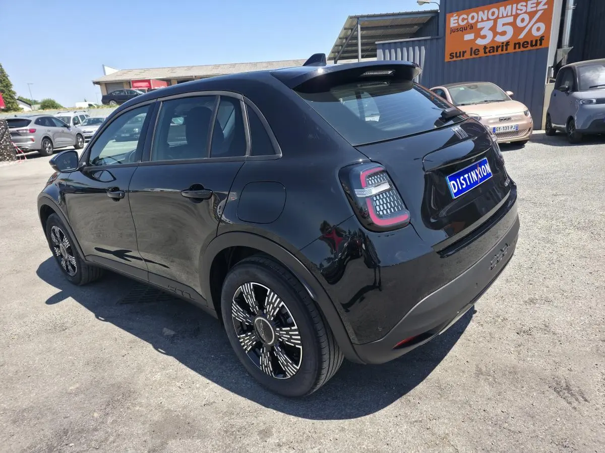 Vue 3/4 arrière droite d'une FIAT 600 noire 2025 avec jantes alliage et feux arrière LED distinctifs.