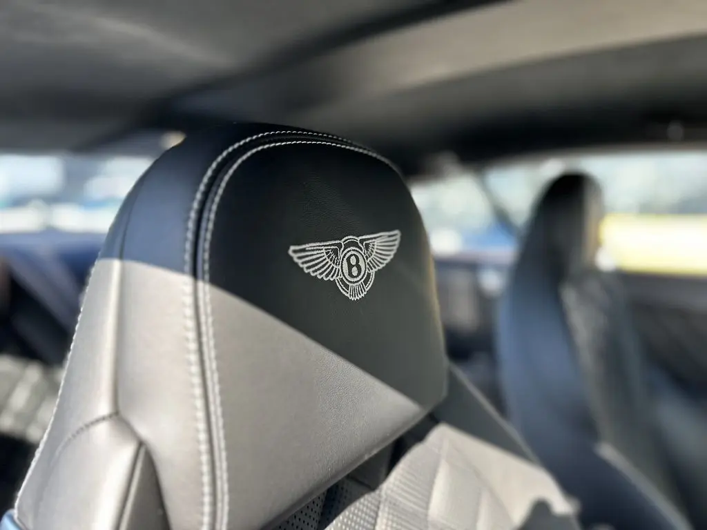 Gros plan sur l'appui-tête en cuir noir avec logo Bentley brodé à l'intérieur d'une Continental GT Speed 2015.