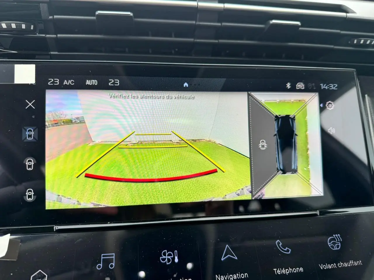 Écran tactile intérieur du Peugeot 308 SW blanc montrant la caméra de recul avec vue 360° et guidage de trajectoire.