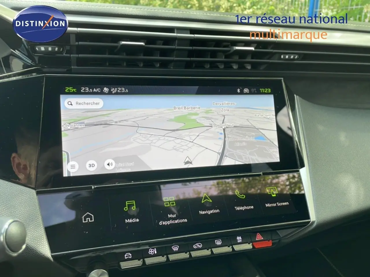 Vue intérieure du tableau de bord de la Peugeot 308 gris Artense, avec écran tactile de navigation allumé.