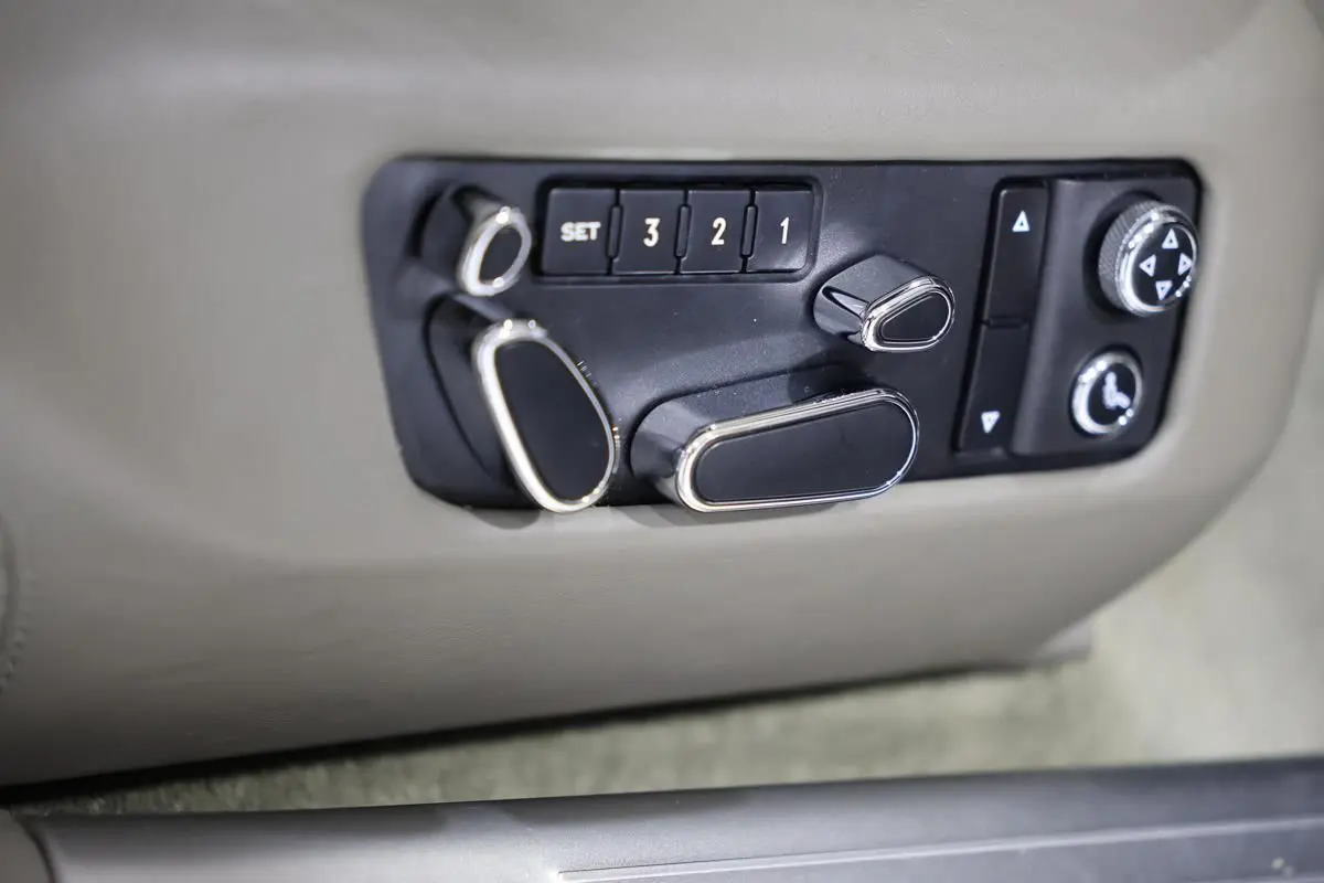 Détail des commandes de réglage électrique des sièges en cuir beige dans une Bentley Continental Flying Spur 2006.