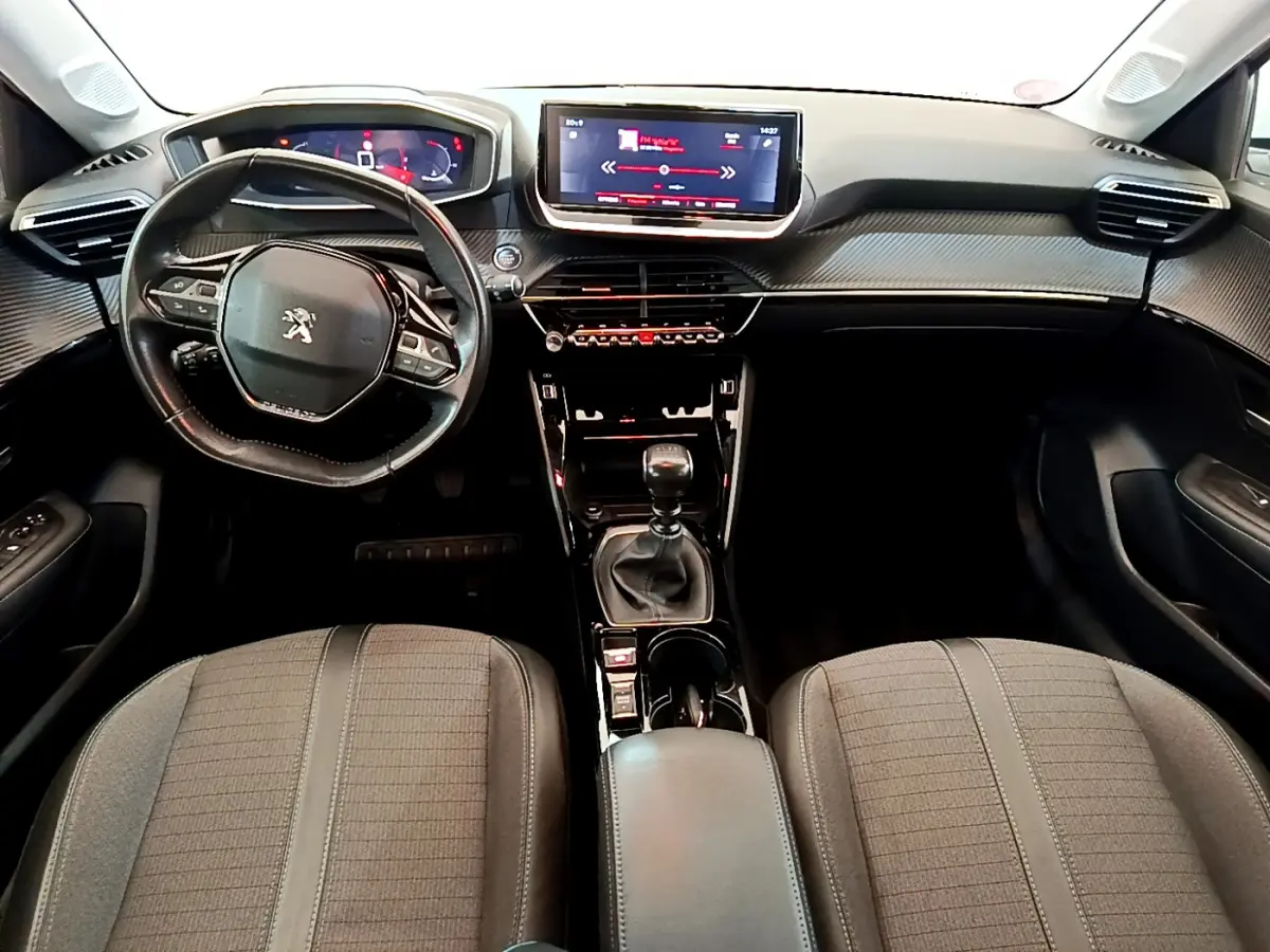 Intérieur Peugeot 208 PureTech 100 vue de face, tableau de bord avec écran tactile et volant cuir noir.