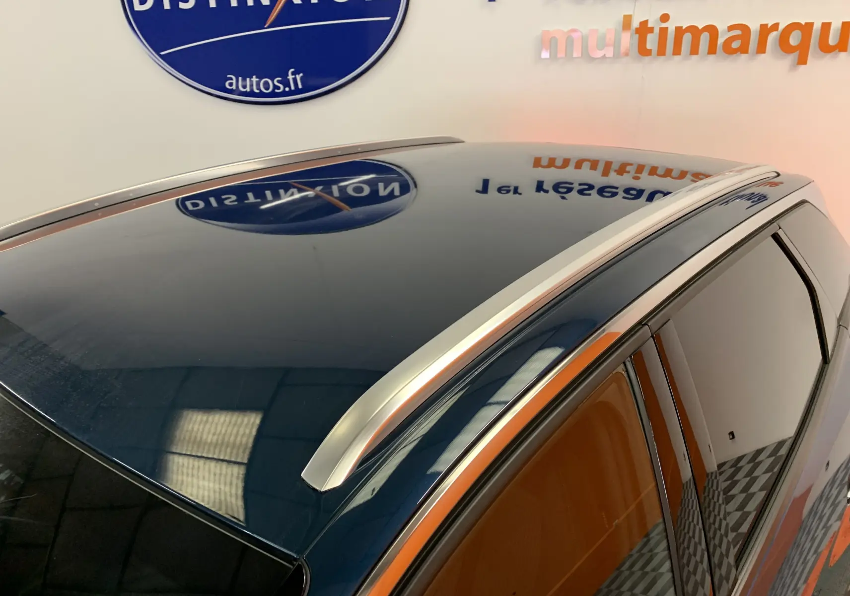 Vue rapprochée du toit bleu Célèbes du Peugeot 3008 avec barres de toit argentées et vitres teintées.