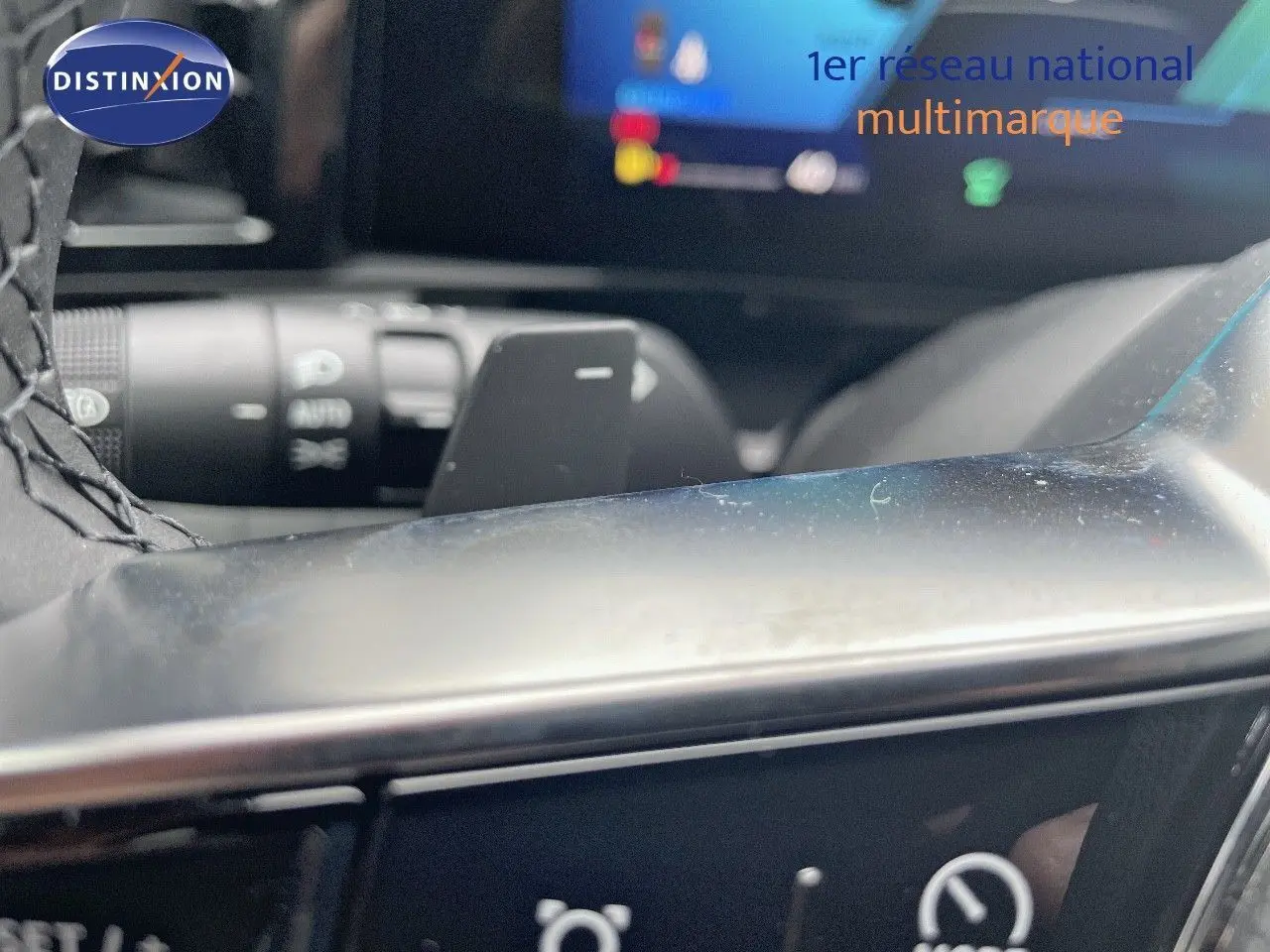 Gros plan sur la commande au volant du Renault Austral blanc nacré, mettant en valeur les boutons multifonctions.