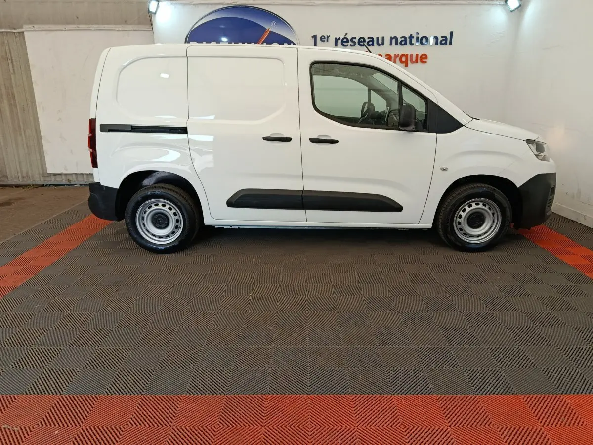 Vue de profil côté gauche d’un utilitaire Citroën Berlingo blanc, version Taille M, avec porte latérale coulissante et jantes acier.