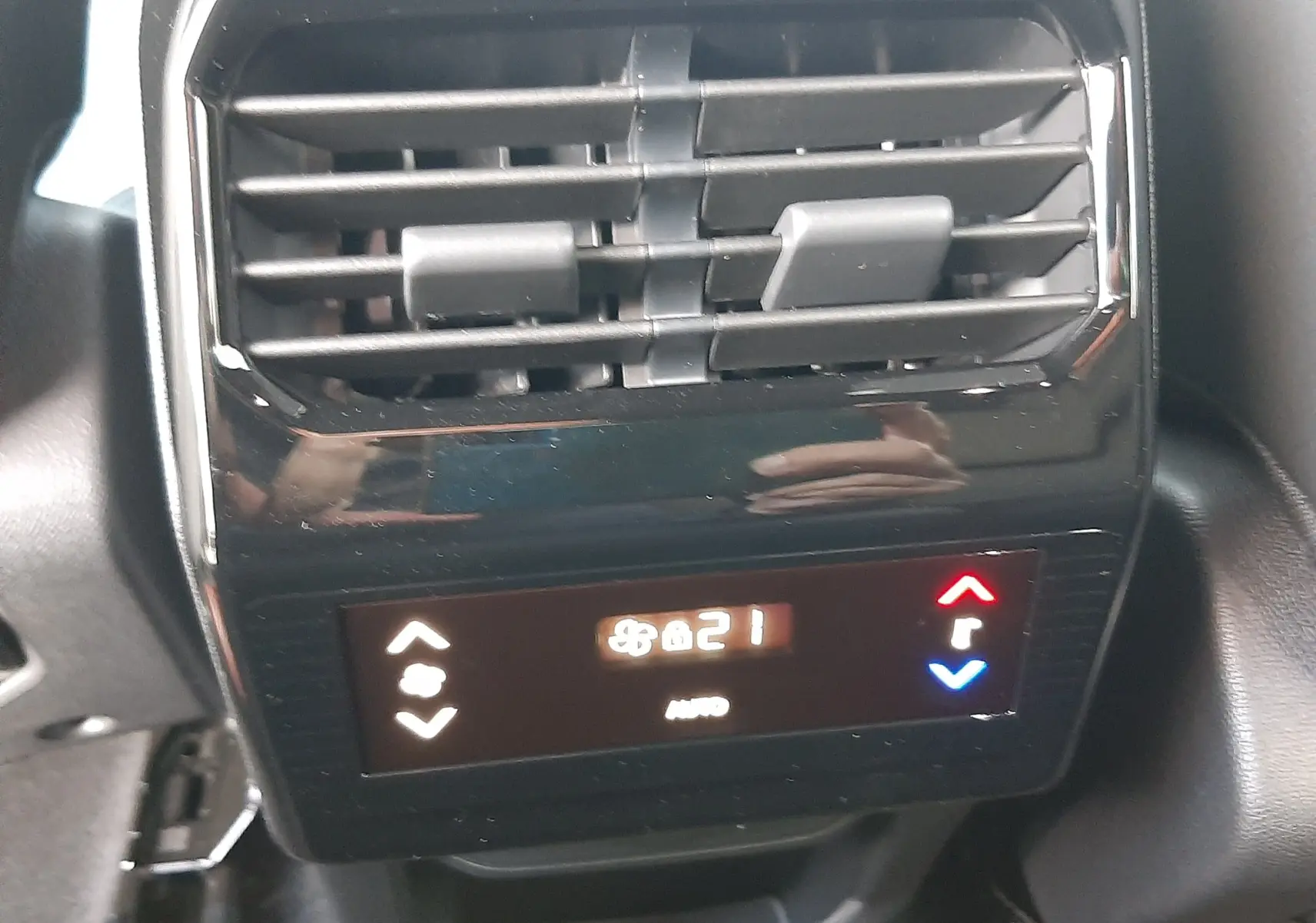 Commande de climatisation arrière noire avec affichage digital à 21°C dans un Peugeot 5008 bleu Ingaro 2025.