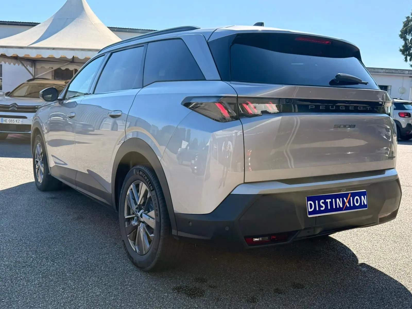 Peugeot 5008 gris Artense vue 3/4 arrière droit, avec feux arrière LED et jantes alliage distinctives.