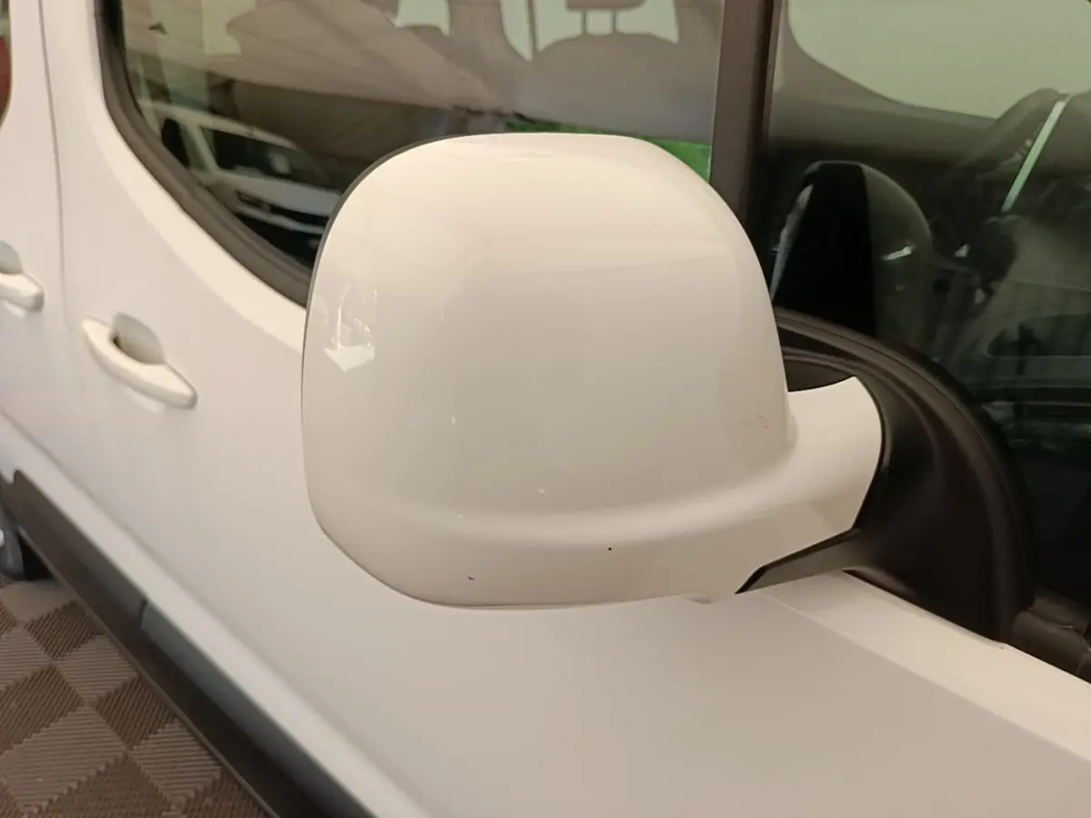 Gros plan sur le rétroviseur droit blanc du Peugeot Rifter 2020, avec porte et fenêtre arrière visibles.