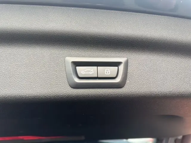 Boutons de commande pour ouverture et verrouillage du coffre sur le hayon intérieur d'un BMW X1 Storm Bay 2024.