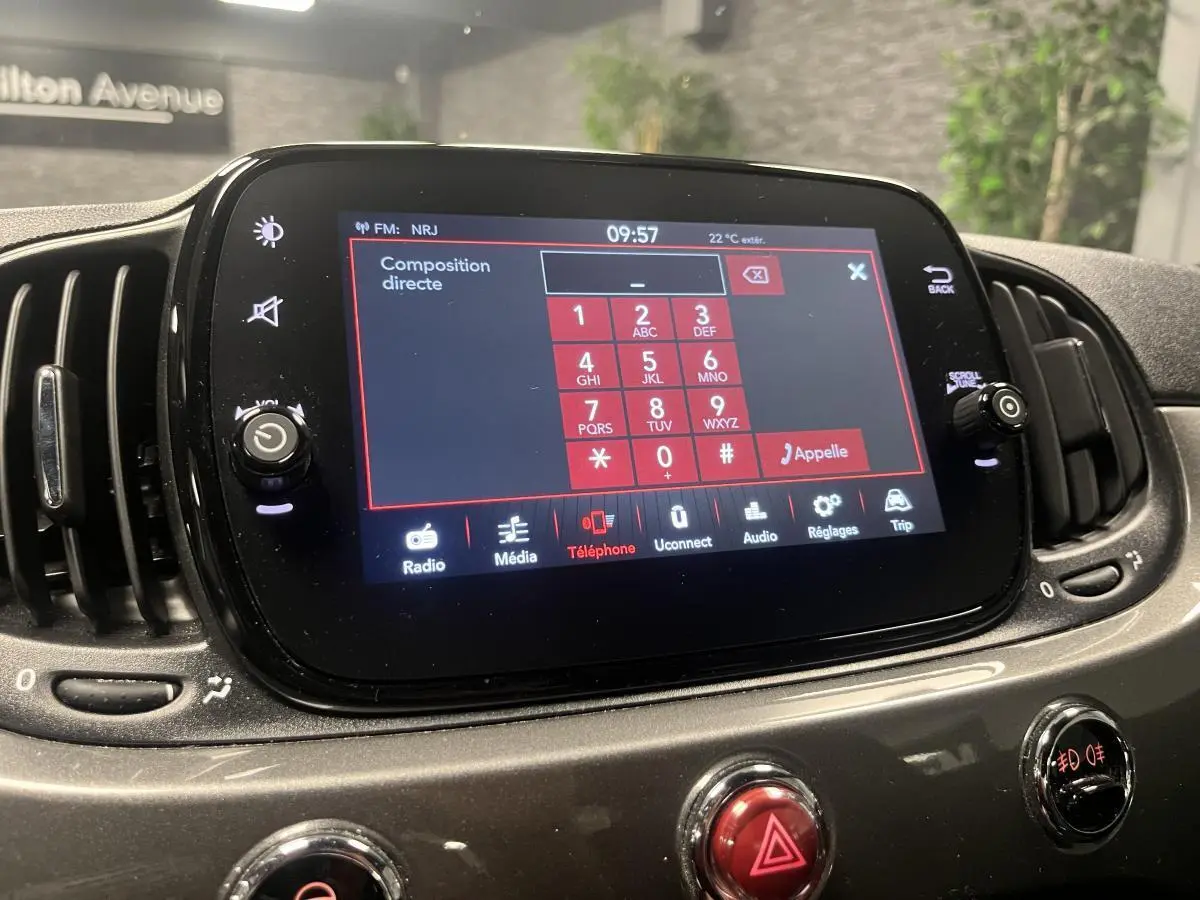 Écran tactile central du tableau de bord de la Fiat 500 gris, affichant le menu téléphone en mode composition.