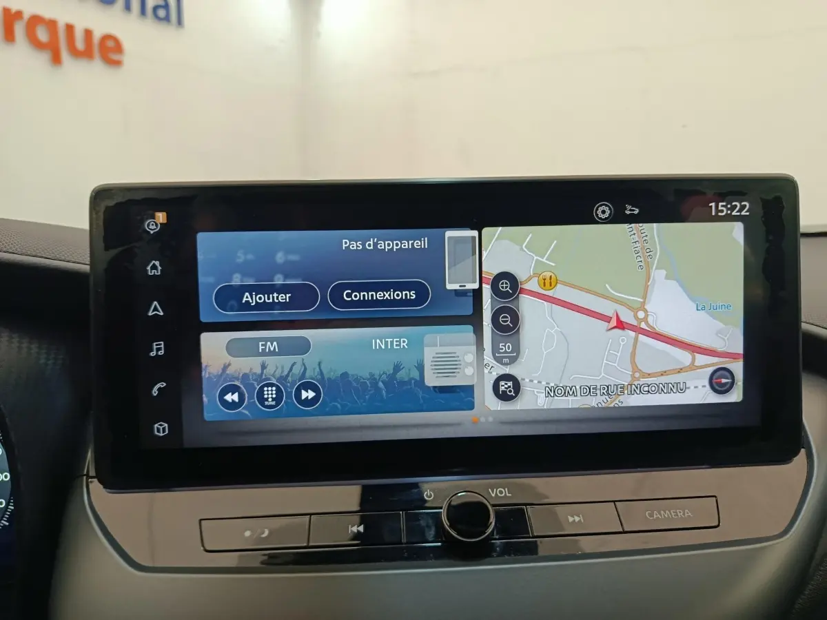 Écran tactile central du tableau de bord du Nissan Juke gris clair, affichant navigation et options multimédia.