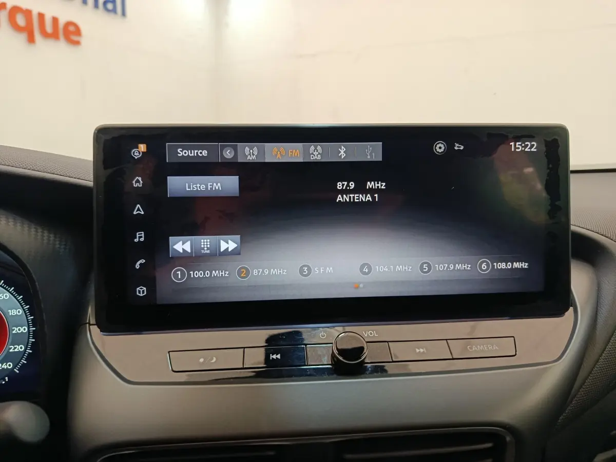 Écran tactile central affichant la radio FM dans l'habitacle du Nissan Juke gris clair, version 2025.