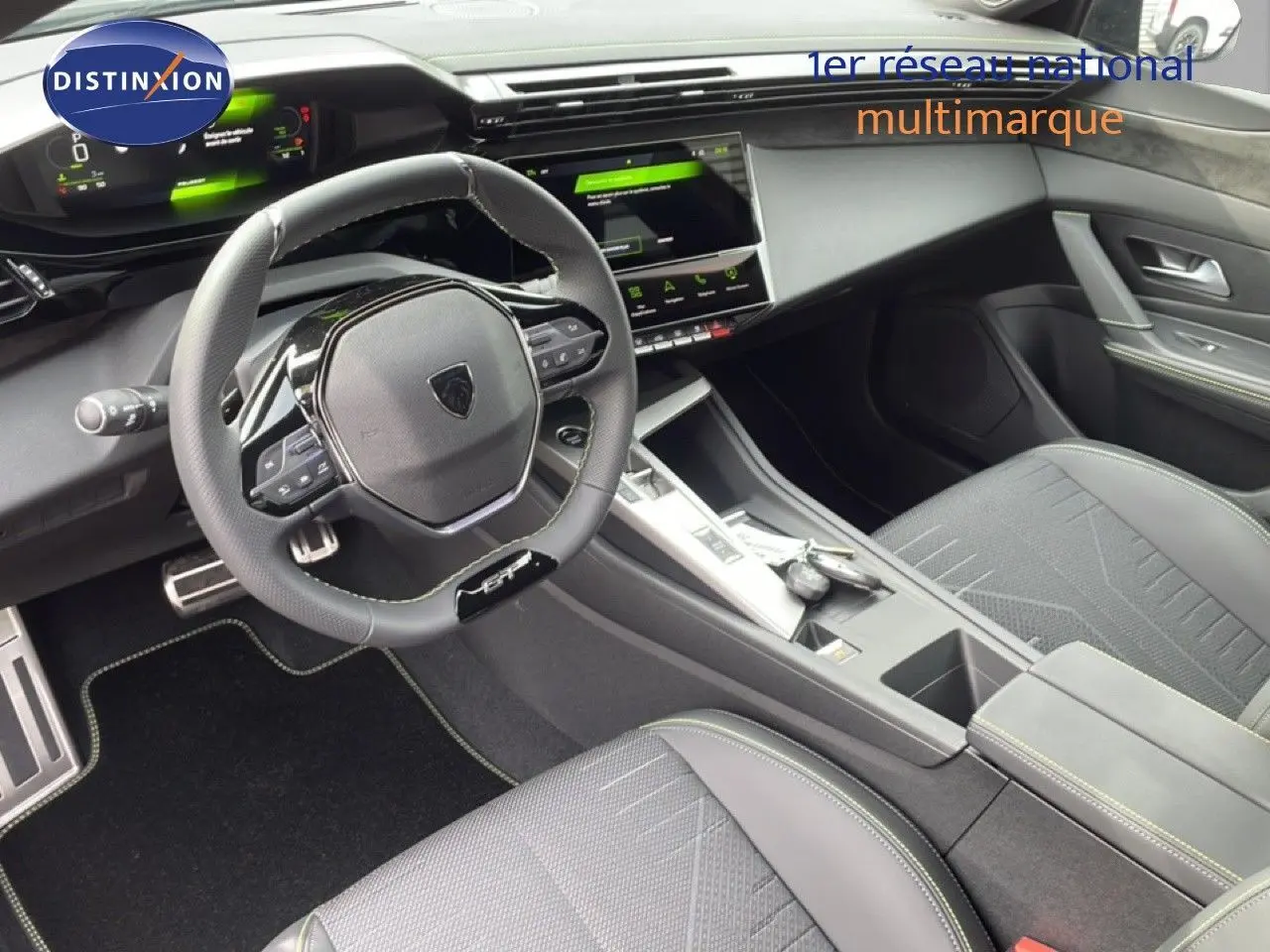 Vue intérieure de la Peugeot 308 1.2 Hybrid 145ch GT, montrant le volant multifonction et la console centrale moderne.