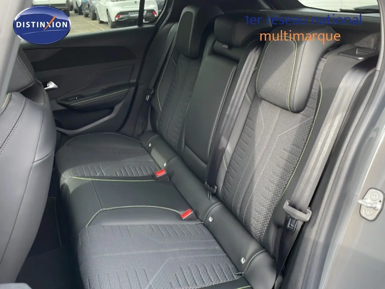 Vue intérieure côté droit des sièges arrière en tissu et cuir noir avec surpiqûres vertes d'une Peugeot 308 gris selenium 2026.