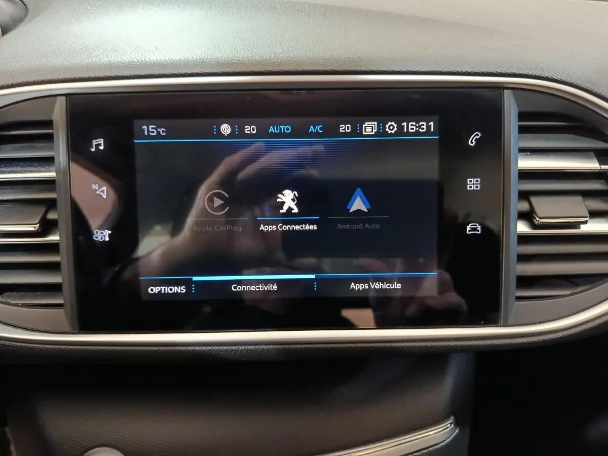 Écran tactile central du tableau de bord de la Peugeot 308 blanc, affichant les apps connectées Apple CarPlay et Android Auto.