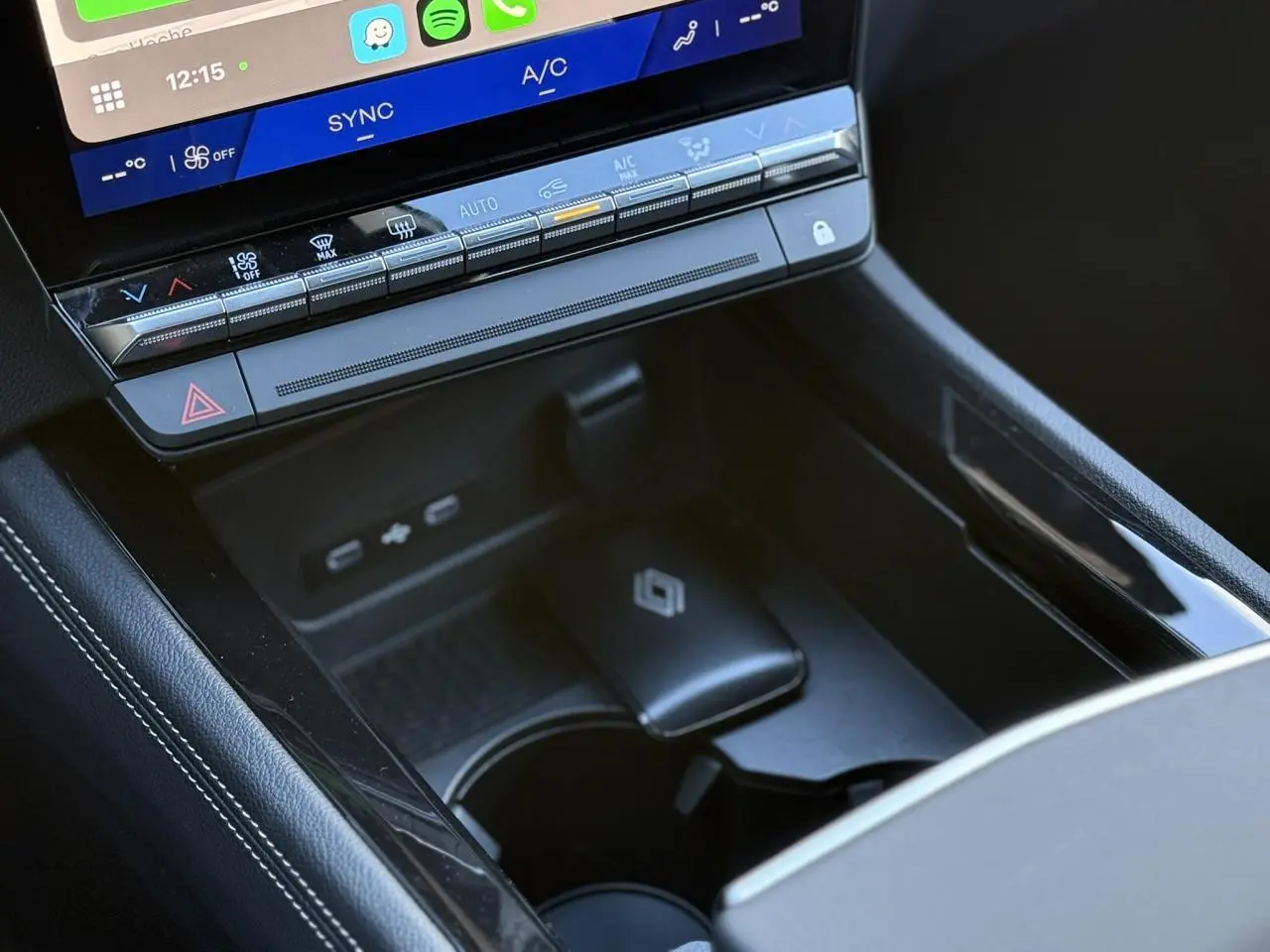 Gros plan sur la console centrale noire du Renault Espace VI avec écran tactile et commandes climatisation.