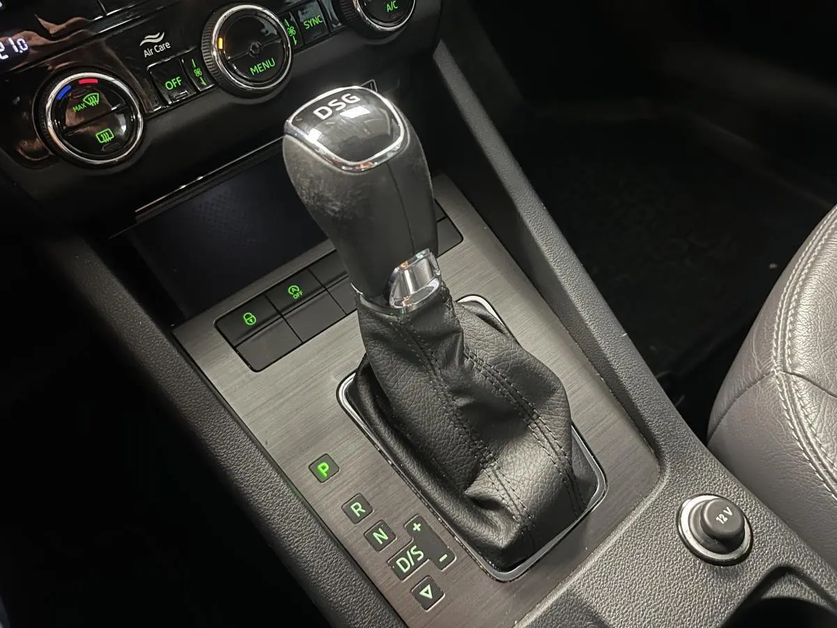 Le levier de vitesses DSG noir en cuir de la Skoda Octavia 2020, avec console centrale grise et commandes éclairées.