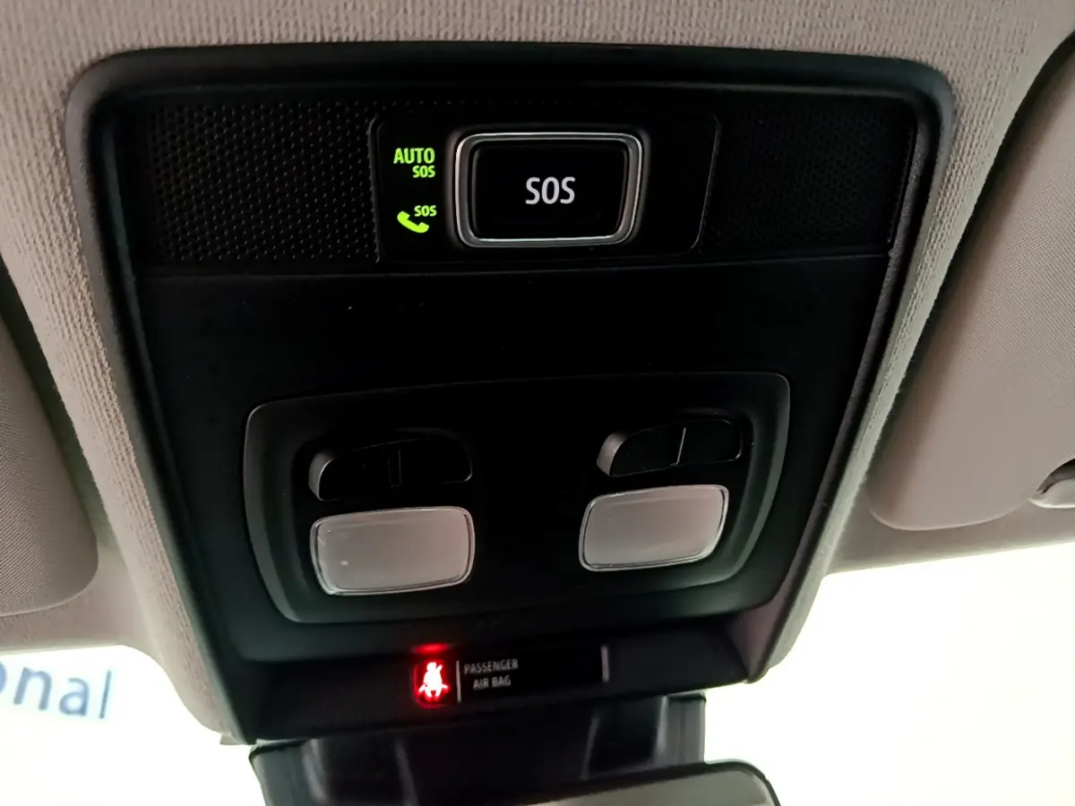 Vue en gros plan du plafonnier avec bouton SOS et voyants d'airbag dans l'habitacle d'une Renault Clio blanche 2020.