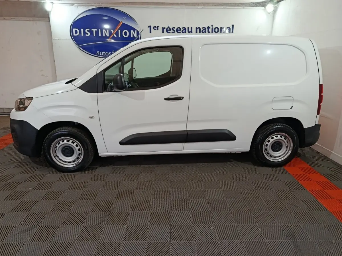 Profil droit d'un utilitaire Citroën Berlingo blanc 2021 avec jantes acier et protections noires sur les portes.