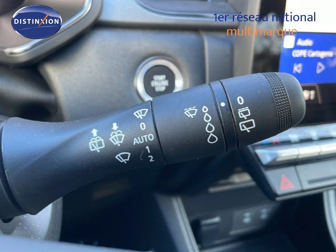 Gros plan sur la commande d'essuie-glace du Renault Captur 2025, intérieur noir avec bouton start/stop visible.