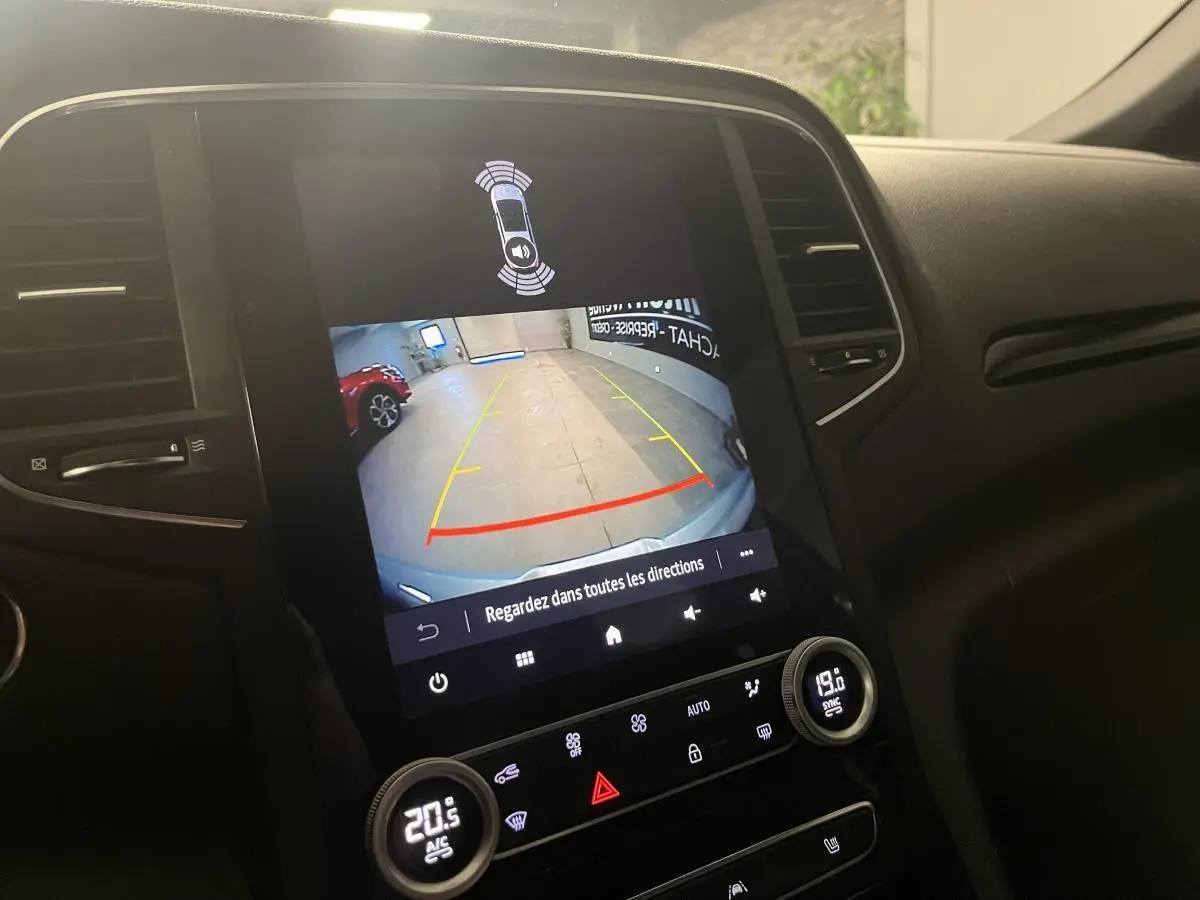Écran tactile central de la Renault Mégane gris affichant la caméra de recul avec guidage dynamique en intérieur.
