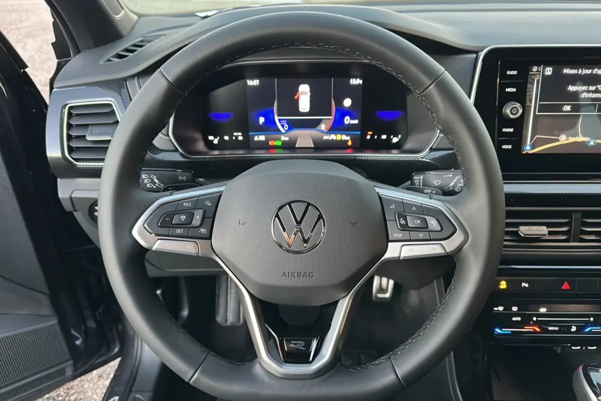 Vue intérieure centrée sur le volant cuir multifonctions du Volkswagen T-Cross TSI 116 DSG7 R-Line 2025.