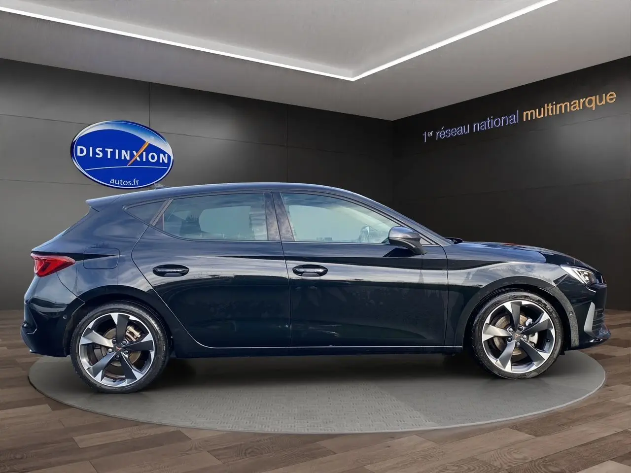 Vue de profil côté gauche d'une CUPRA Leon noire 5 portes 2023 avec jantes alliage et toit ouvrant panoramique.