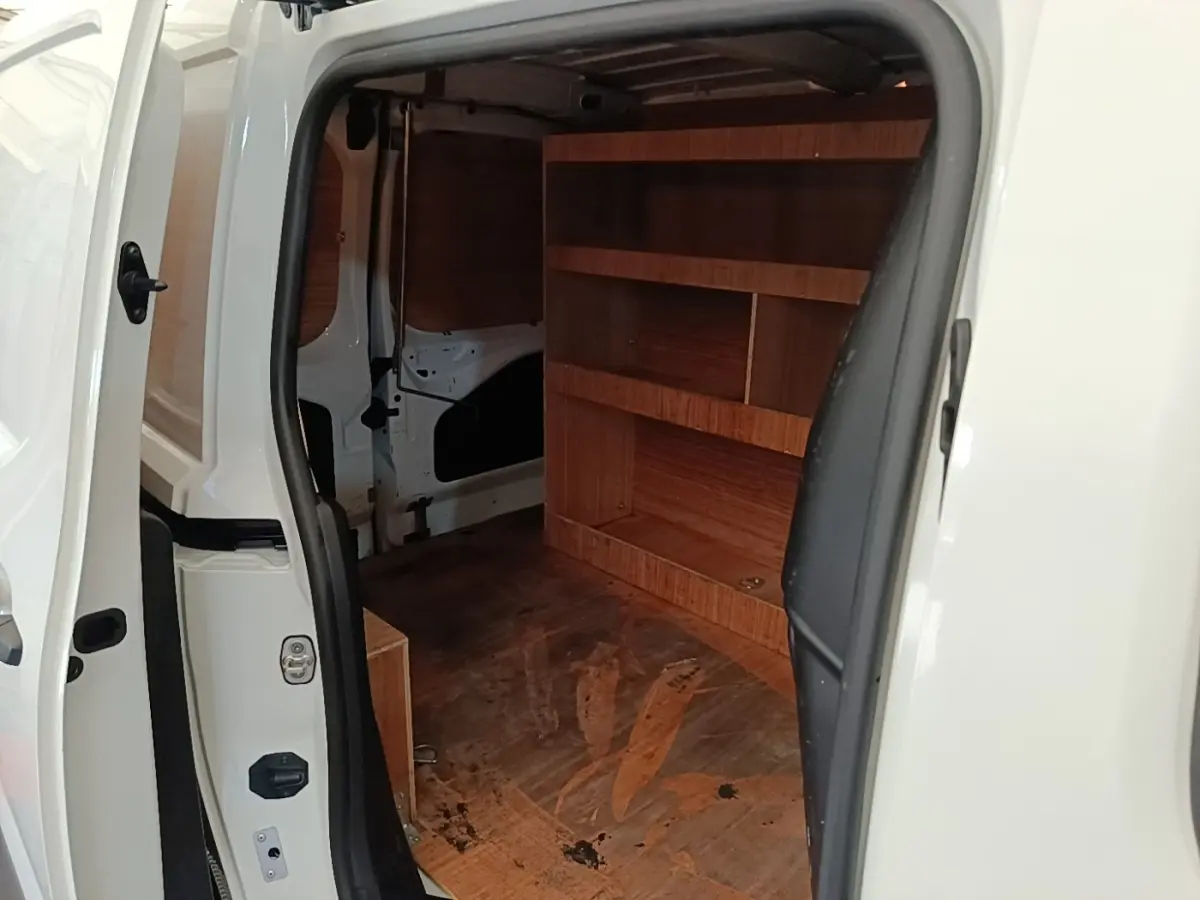 Vue intérieure côté droit du Citroën Berlingo blanc 2021, montrant l’espace de chargement avec étagères en bois.
