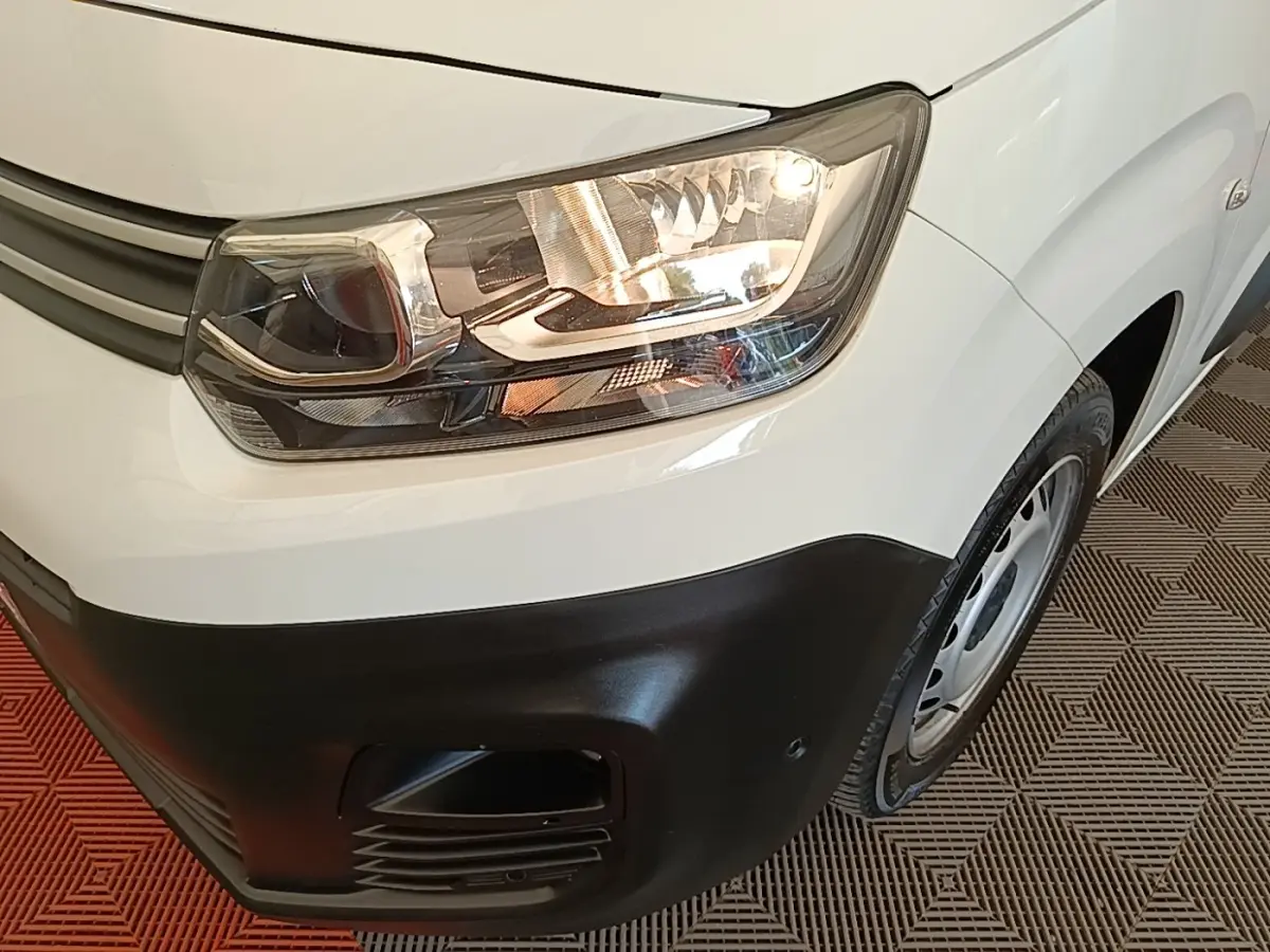 Gros plan sur l'avant droit blanc du Citroën Berlingo 2021 avec phare allumé et pare-chocs noir mat.