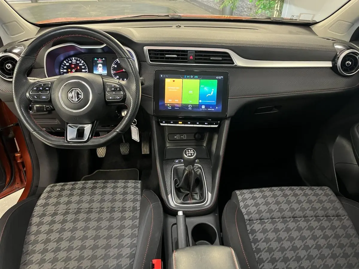 Intérieur MG ZS 2022 vu de face, volant cuir avec commandes, écran tactile 10,1 pouces et levier de vitesses manuel.