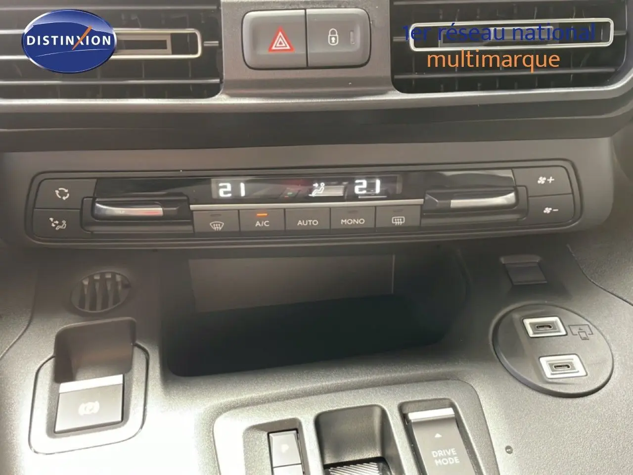 Vue rapprochée de la console centrale du Citroën Berlingo gris avec commandes climatisation digitale et ports USB.