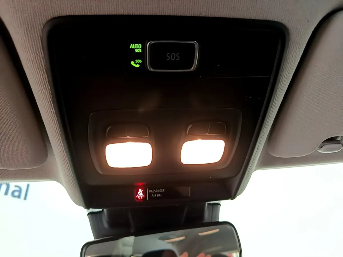 Vue intérieure du plafonnier avec éclairage allumé et témoin d'airbag passager dans une Renault Clio blanche de 2020.