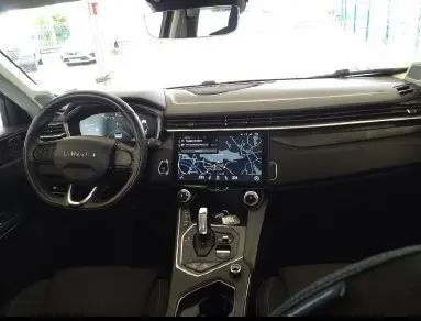 Vue arrière d'un SUV LYNK & CO 01 noir avec feux LED allumés et double sortie d'échappement visible.