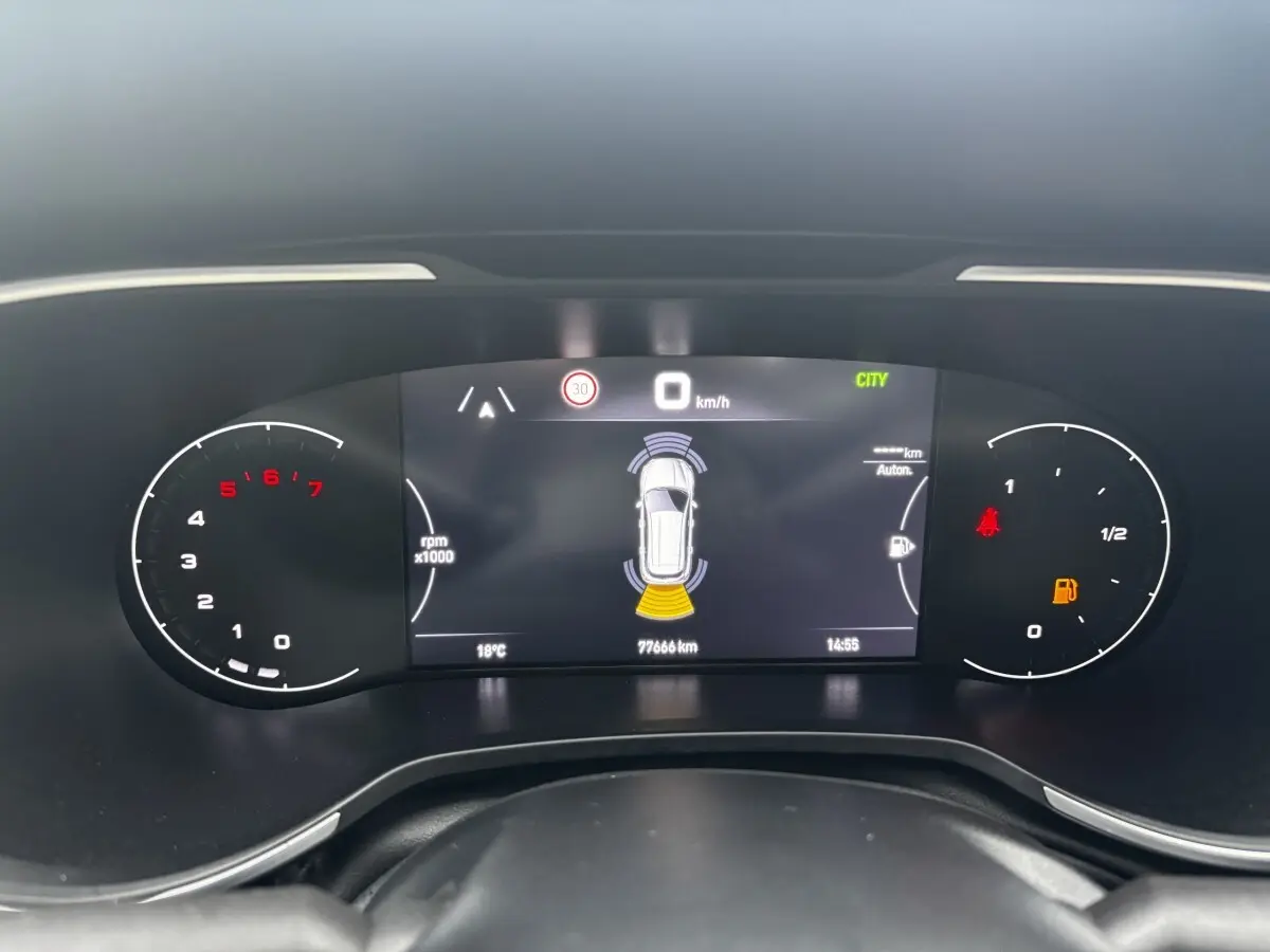 Tableau de bord numérique de la Fiat Tipo blanc, affichant la vitesse à 0 km/h et indicateurs de parking actif.