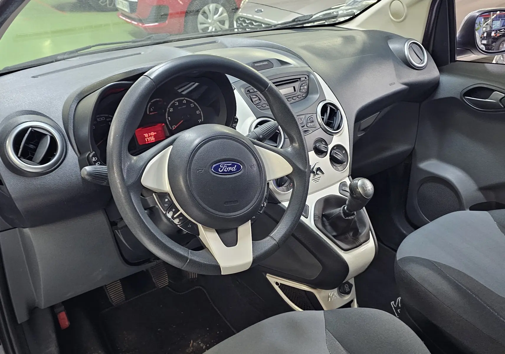 Intérieur avant droit du Ford KA+ gris 2016, volant noir avec inserts clairs et tableau de bord compact.