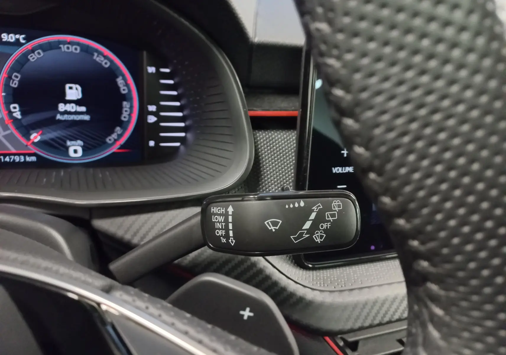 Gros plan sur le commodo d'essuie-glace et tableau de bord numérique d'une Skoda Scala Gris Graphite 2025.