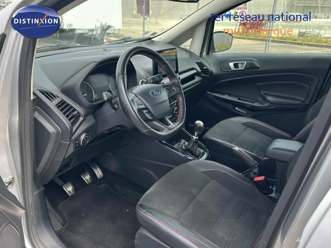 Vue intérieure côté conducteur du Ford EcoSport gris clair 2018, avec volant multifonction et boîte manuelle.