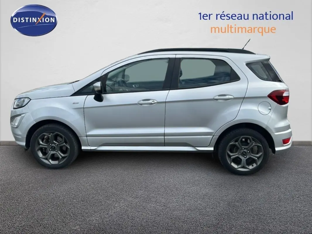 Vue latérale droite d'un Ford EcoSport gris clair 2018 avec jantes alliage 17 pouces et barres de toit noires.