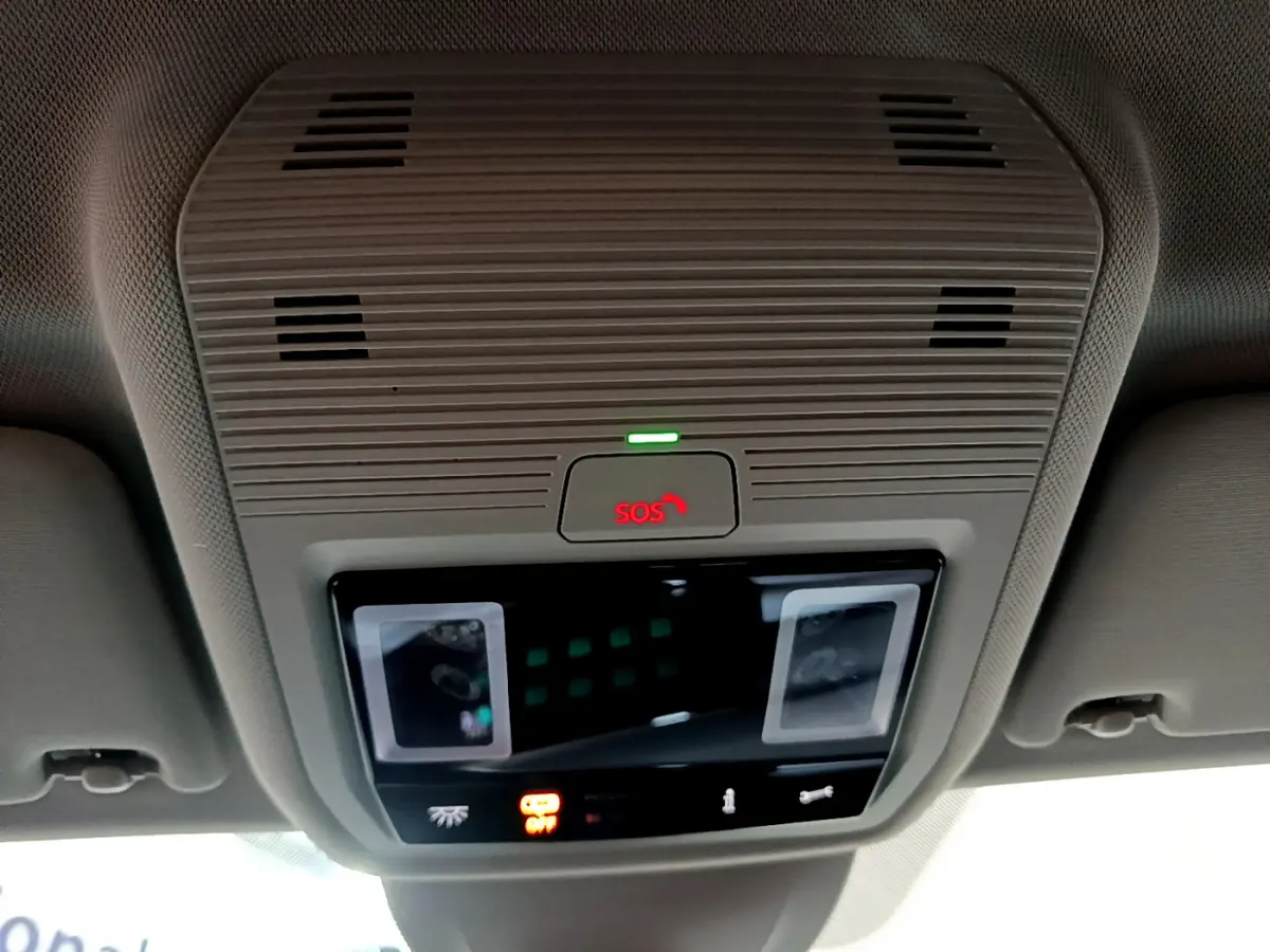 Vue en gros plan du plafonnier intérieur gris avec bouton SOS illuminé en rouge dans une Volkswagen Golf bleue