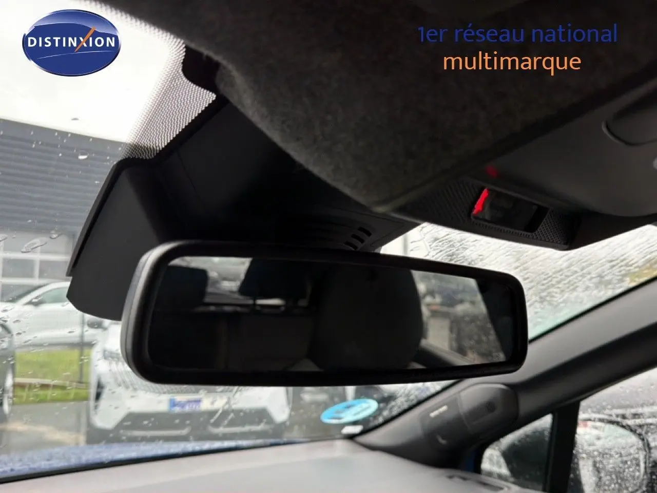 Rétroviseur intérieur du Renault Captur bleu Iron Metal 2025, avec vue partielle sur l’habitacle et l’extérieur sous la pluie.