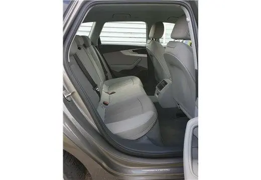 Vue intérieure arrière gauche de l'Audi A4 Avant Business 30 TDI 2020 en gris Terra, sièges arrière en tissu clair et espace passagers.