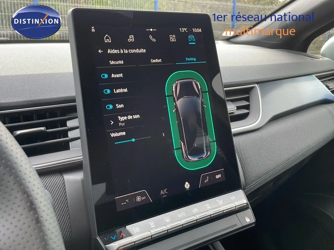 Vue intérieure du tableau de bord du Renault Captur noir étoile métal, avec écran tactile central affichant les aides à la conduite.
