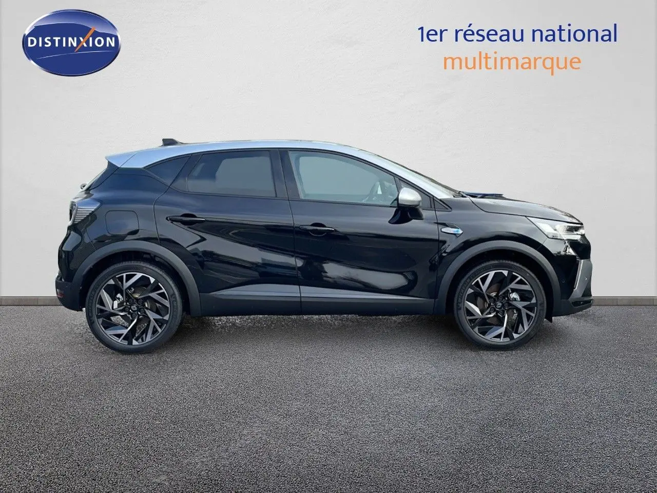 Renault Captur E-Tech hybride 2025 noir étoile avec toit gris vu de profil côté gauche, jantes alliage distinctives.