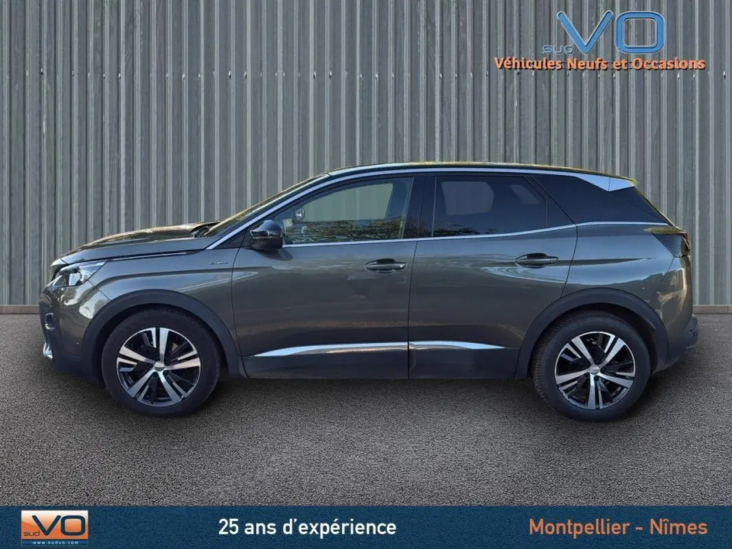 Profil côté gauche du Peugeot 3008 GT Line gris foncé de 2018 avec jantes alliage 18 pouces sur fond neutre.