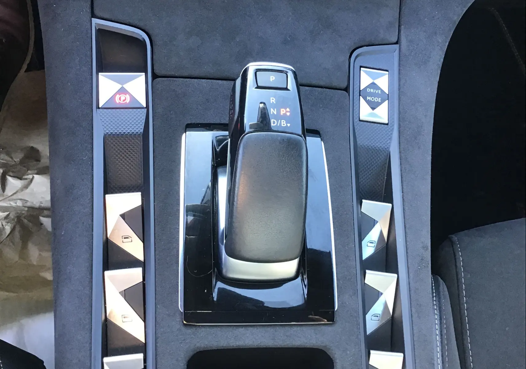 Vue rapprochée de la console centrale noire du DS7 Crossback 2023 avec levier de vitesses et boutons argentés.
